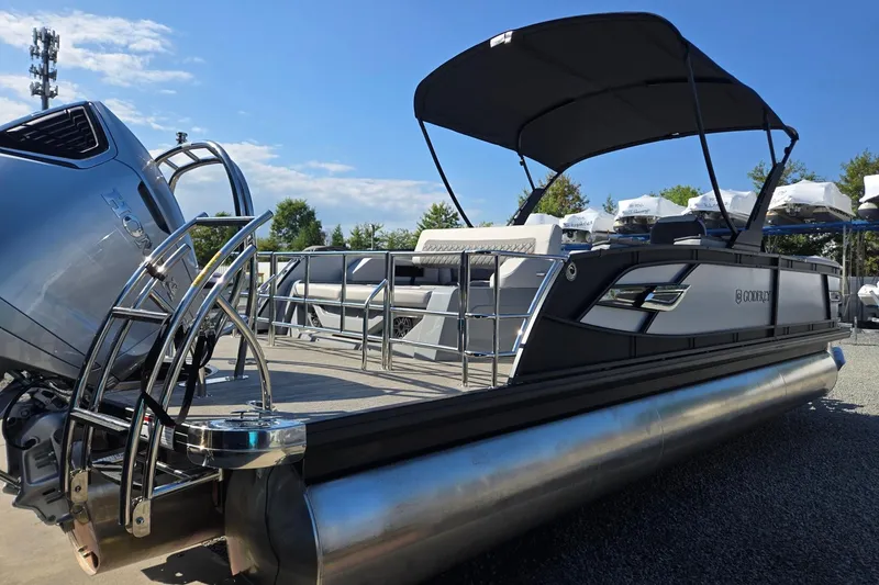 Slide: The Image of 2026 Godfrey AquaPatio 255 SFL pontoon boat with canopy and sleek design. - 5