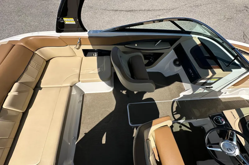 Slide: The Image of 2015 Sea Ray 230 SLX boat interior with tan seating and steering wheel. - 11