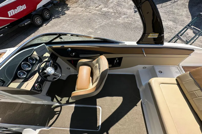 Slide: The Image of 2015 Sea Ray 230 SLX boat interior with steering wheel and seating. - 12