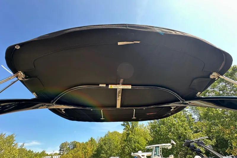 Slide: The Image of 2015 Sea Ray 230 SLX boat canopy under clear blue sky. - 13