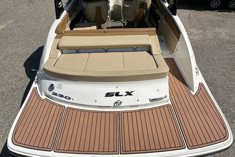 Slide: The Image of 2015 Sea Ray 230 SLX boat with teak-style swim platform and beige seating. - 15