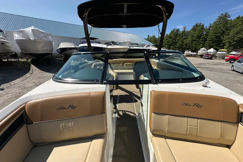 Slide: The Image of 2015 Sea Ray 230 SLX boat interior with tan seating and windshield. - 17