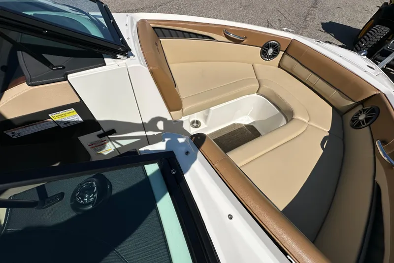 Slide: The Image of Interior of 2015 Sea Ray 230 SLX boat with tan seating and speakers. - 18