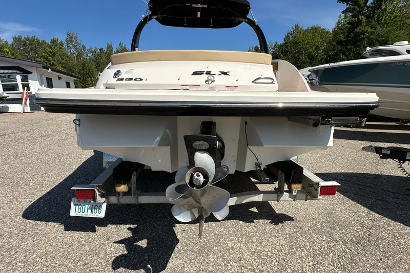 Slide: The Image of 2015 Sea Ray 230 SLX boat on trailer, rear view showing propeller and license plate. - 4