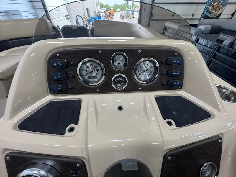 Slide: The Image of Dashboard of 2018 Manitou 21 Aurora LE Standard boat with gauges and controls. - 14