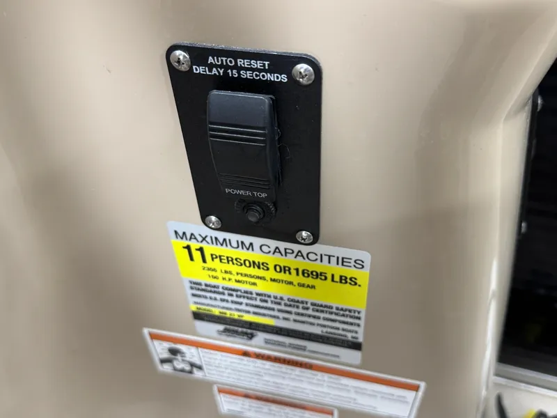 Slide: The Image of 2018 Manitou 21 Aurora LE Standard capacity label, 11 persons or 1695 lbs, with auto reset switch. - 15