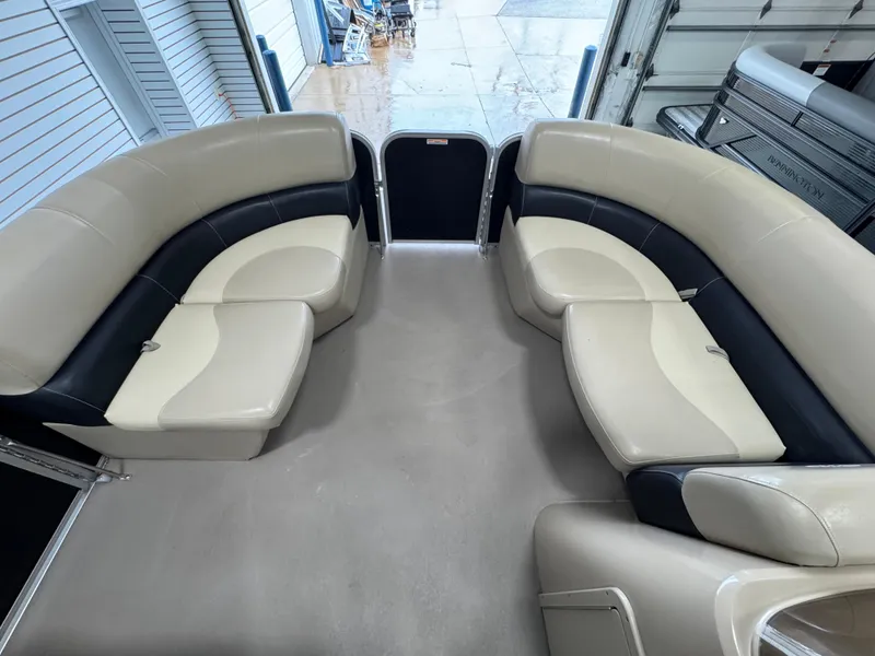 Slide: The Image of 2018 Manitou 21 Aurora LE Standard boat interior with beige and black seating. - 17