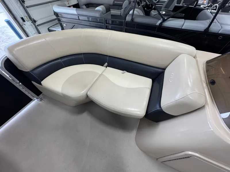 Slide: The Image of 2018 Manitou 21 Aurora LE Standard boat interior with beige and black seating. - 19