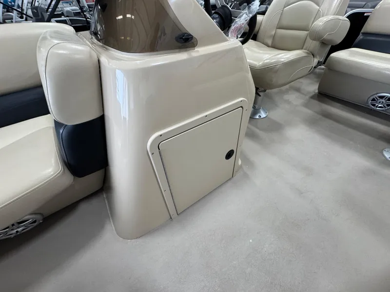 Slide: The Image of 2018 Manitou 21 Aurora LE Standard boat interior with beige seating and storage compartment. - 20