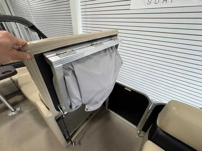 Slide: The Image of 2018 Manitou 21 Aurora LE Standard boat interior with foldable seat storage. - 21