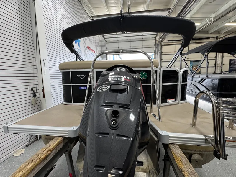 Slide: The Image of 2018 Manitou 21 Aurora LE Standard pontoon boat with outboard motor in a showroom. - 4