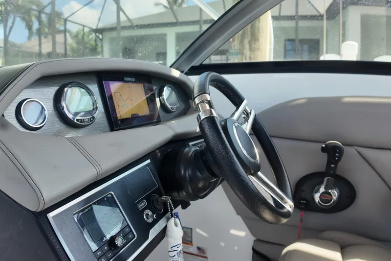 Slide: The Image of Interior of 2022 Four Winns HD8 boat with steering wheel and navigation system. - 10