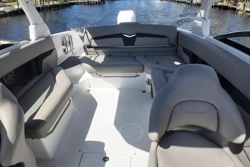 Slide: The Image of 2022 Four Winns HD8 boat interior with spacious seating and elegant design on the water. - 16