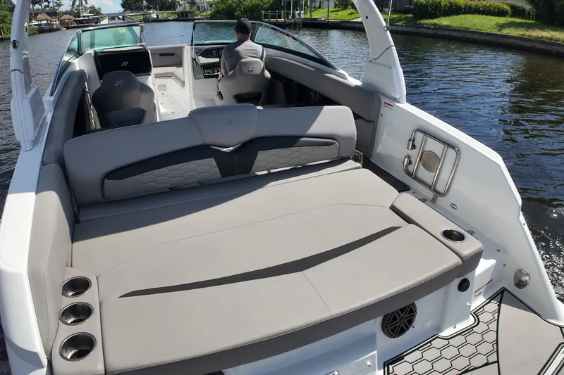 Slide: The Image of 2022 Four Winns HD8 boat interior with spacious seating and modern design on a sunny day. - 19