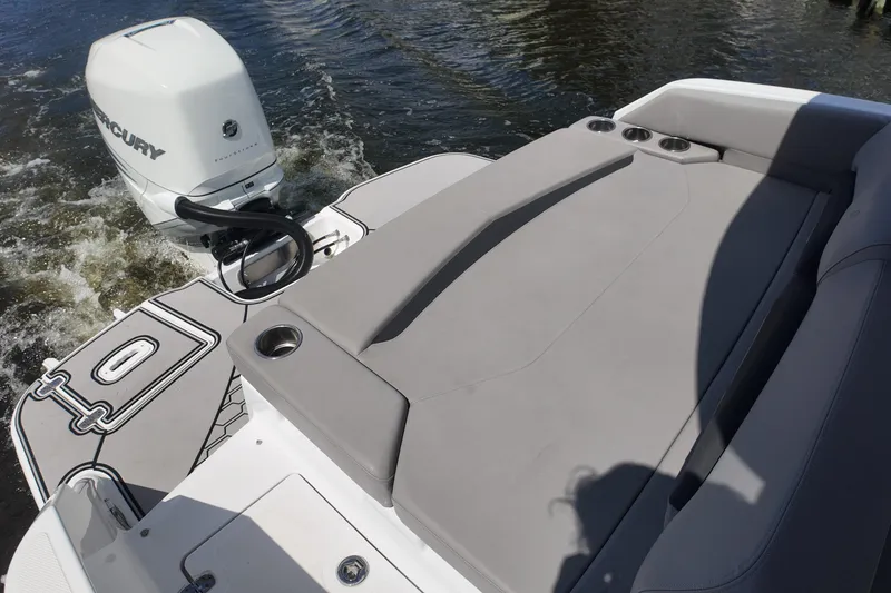 Slide: The Image of 2022 Four Winns HD8 boat with Mercury outboard engine, featuring a spacious sun deck. - 20