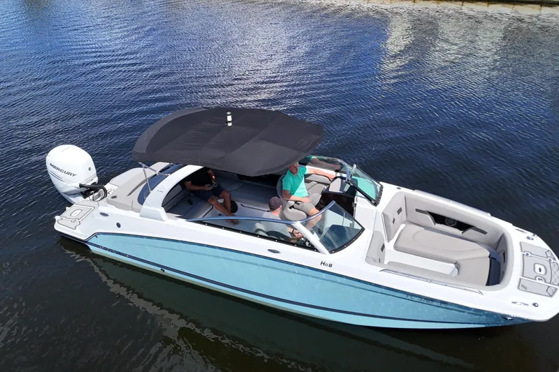 Slide: The Image of 2022 Four Winns HD8 boat on water, featuring sleek design and spacious seating. - 5