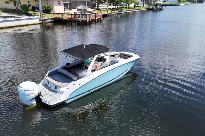 Slide: The Image of 2022 Four Winns HD8 boat cruising on a calm waterway. - 7