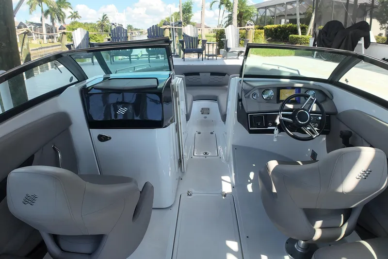 Slide: The Image of Interior of 2022 Four Winns HD8 boat with modern dashboard and seating. - 8
