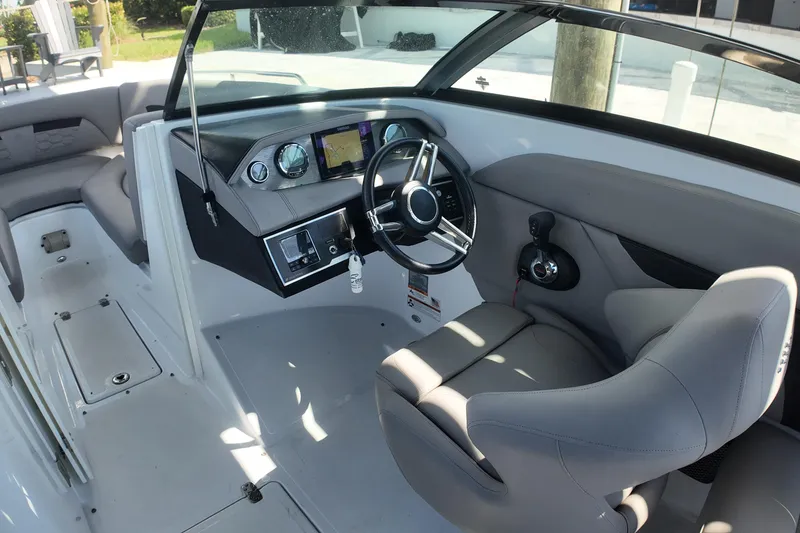 Slide: The Image of 2022 Four Winns HD8 boat interior with modern dashboard and comfortable seating. - 9