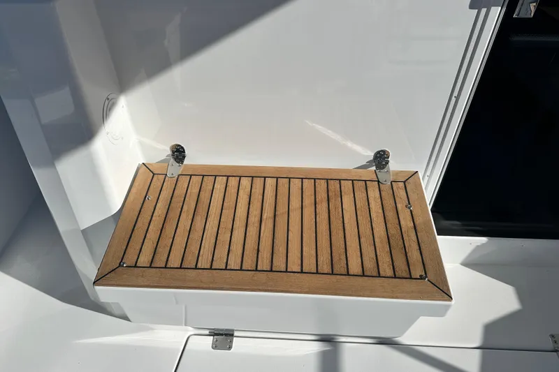 Slide: The Image of Open storage compartment on 2025 Sargo 31OB boat, showcasing interior details. - 13