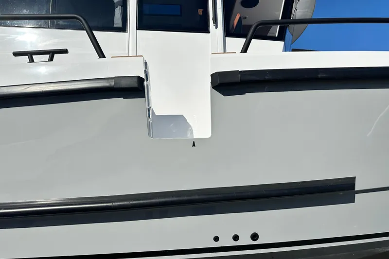 Slide: The Image of Close-up of 2025 Sargo 31OB boat exterior with sleek design and black railings. - 15