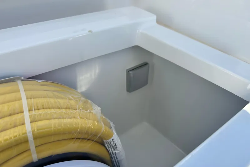 Slide: The Image of Storage compartment with yellow hose in 2025 Sargo 31OB boat. - 18