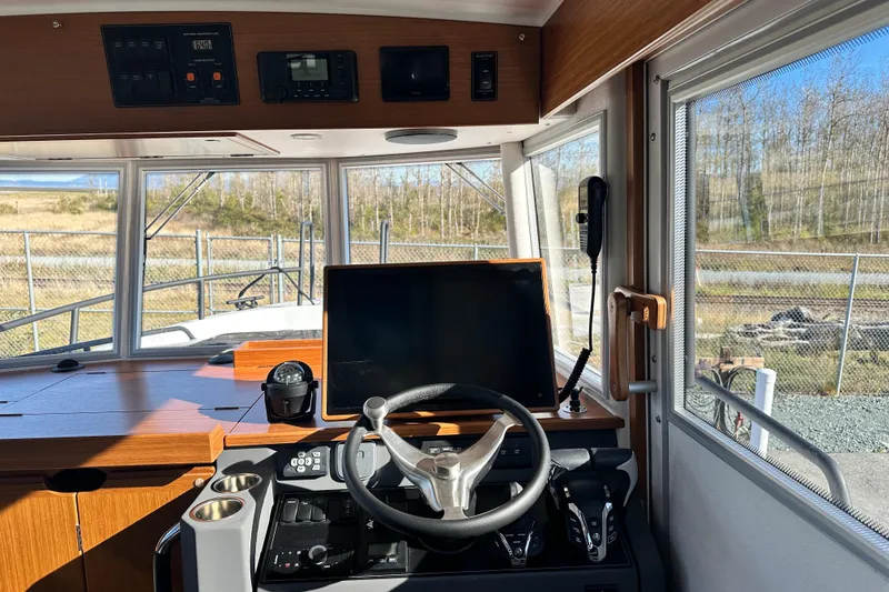 Slide: The Image of Helm of 2025 Sargo 31OB boat with modern navigation equipment and steering wheel. - 22
