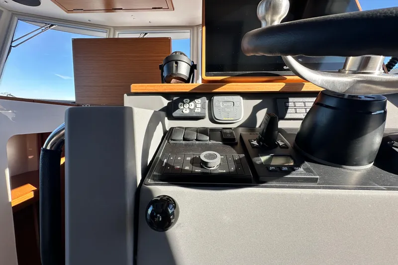 Slide: The Image of Helm of 2025 Sargo 31OB boat with modern controls and steering wheel. - 23