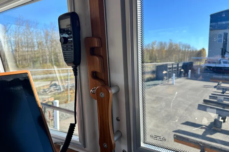 Slide: The Image of Interior of 2025 Sargo 31OB boat showing window and mounted radio handset. - 24