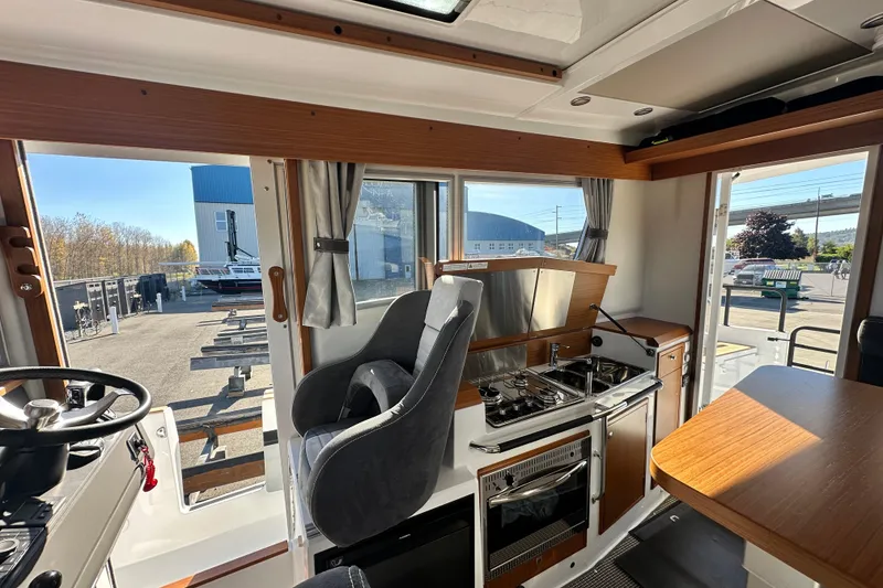 Slide: The Image of Interior of 2025 Sargo 31OB boat with modern kitchen and seating area. - 27