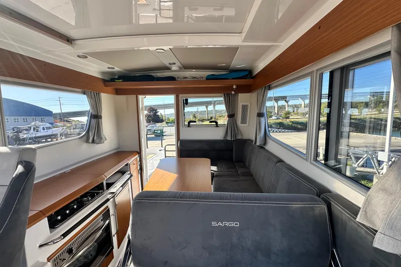 Slide: The Image of Interior of 2025 Sargo 31OB boat with modern seating and kitchen area. - 28