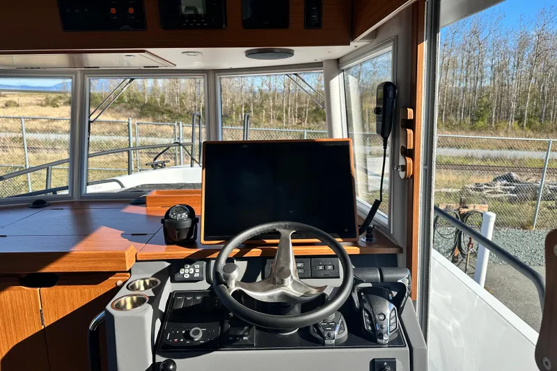 Slide: The Image of Interior view of 2025 Sargo 31OB boat cockpit with steering wheel and navigation equipment. - 31