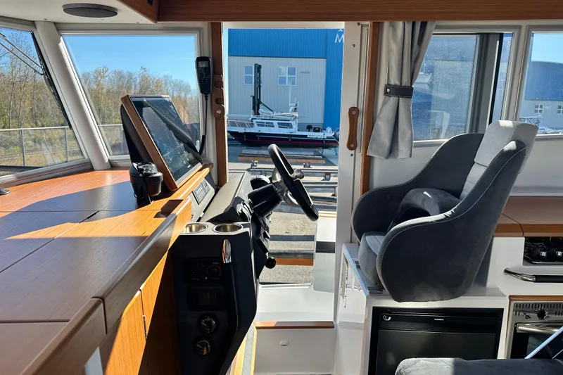Slide: The Image of Interior of 2025 Sargo 31OB boat with modern helm and comfortable seating. - 32