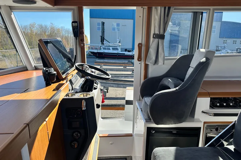 Slide: The Image of Interior of 2025 Sargo 31OB boat with modern helm and seating. - 33