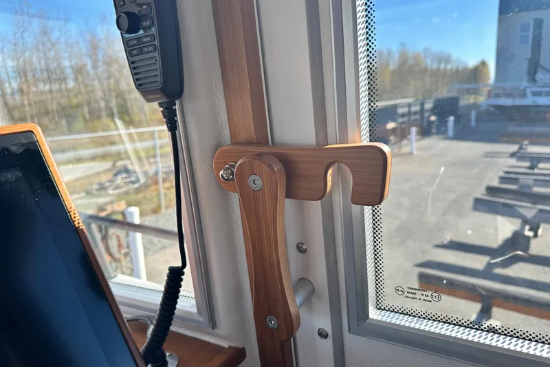 Slide: The Image of Interior of 2025 Sargo 31OB boat with wooden handle and communication device. - 36