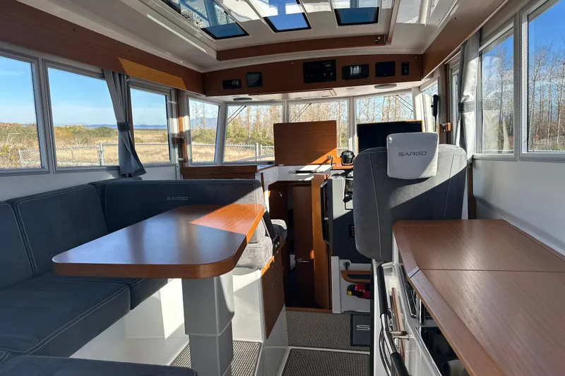 Slide: The Image of Interior of 2025 Sargo 31OB boat with modern seating and panoramic windows. - 37