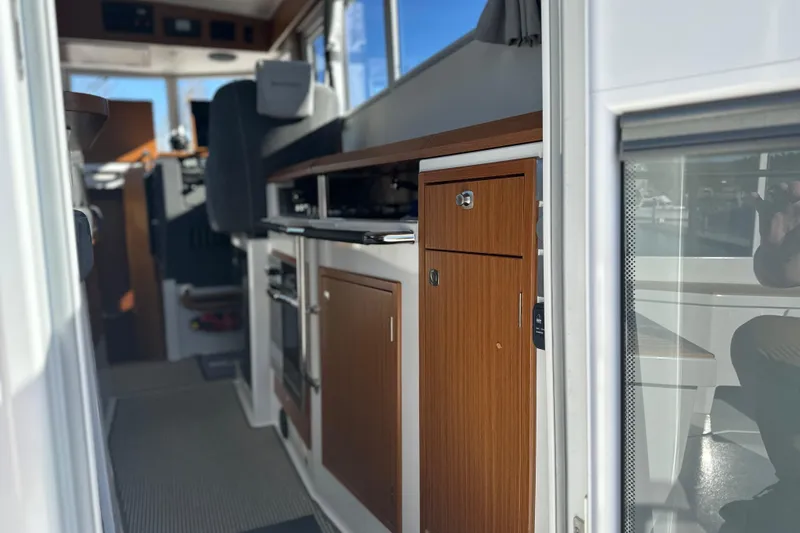 Slide: The Image of Interior view of 2025 Sargo 31OB boat, featuring modern kitchen cabinetry and seating. - 38