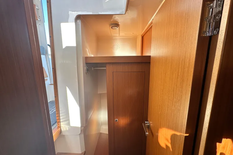 Slide: The Image of Interior of 2025 Sargo 31OB boat, featuring wooden cabinetry and compact design. - 40
