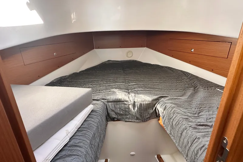 Slide: The Image of 2025 Sargo 31OB cabin interior with cozy bedding and wooden accents. - 47