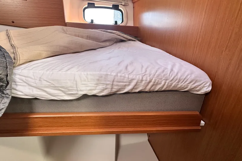 Slide: The Image of Interior cabin of 2025 Sargo 31OB boat with cozy bed and window. - 48