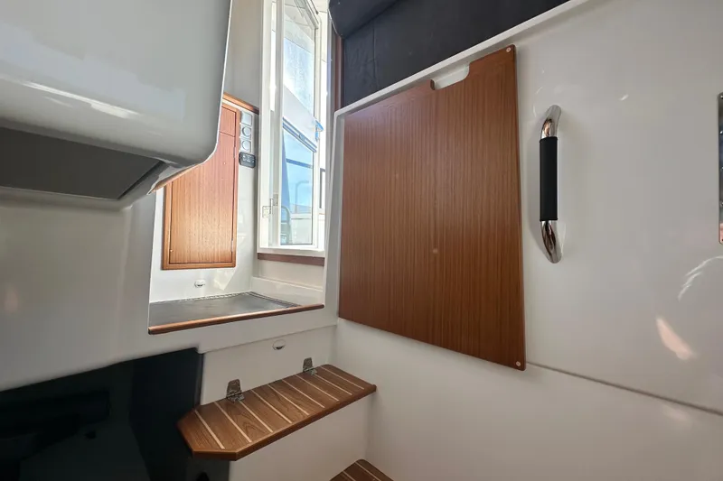 Slide: The Image of Interior of 2025 Sargo 31OB boat with wooden accents and steps. - 52