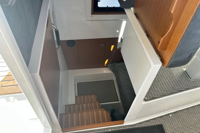 Slide: The Image of Interior cabin view of 2025 Sargo 31OB boat with wooden steps and modern design. - 53