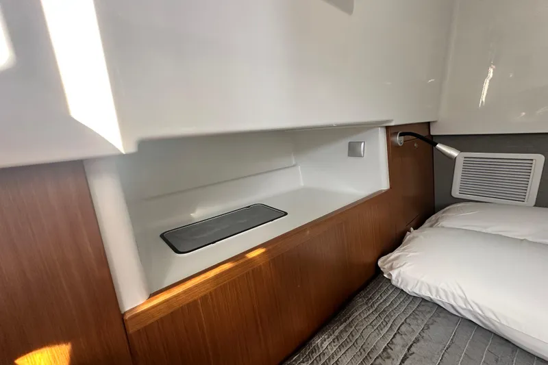 Slide: The Image of Interior cabin of 2025 Sargo 31OB boat with modern wood and white design. - 54