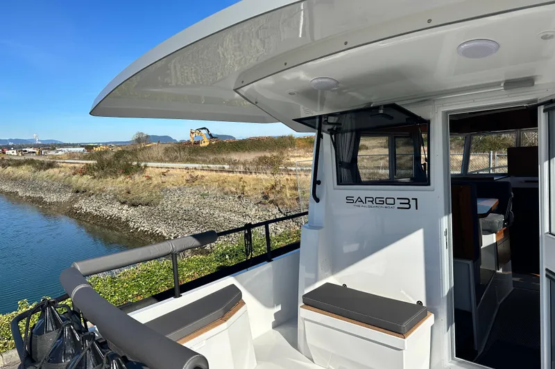 Slide: The Image of 2025 Sargo 31OB boat docked at marina under clear blue sky. - 7