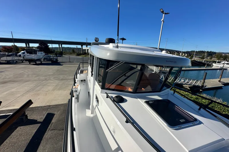 Slide: The Image of 2025 Sargo 31OB boat deck with wooden seating and sleek design. - 8