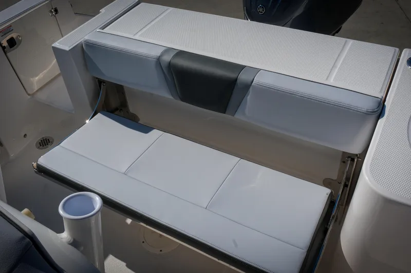 Slide: The Image of 2025 Robalo R230 Center Console boat seating area with cup holder. - 10