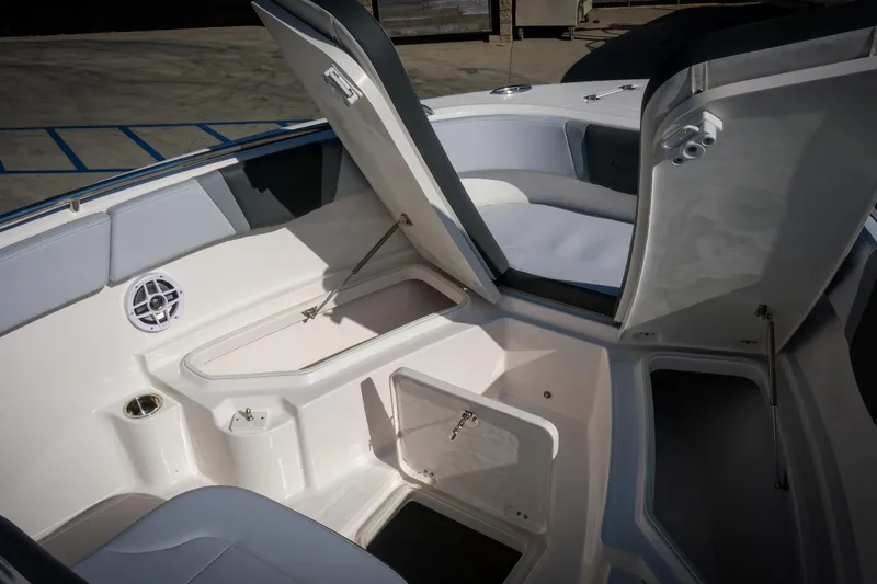 Slide: The Image of 2025 Robalo R230 Center Console boat interior with open storage compartments. - 14