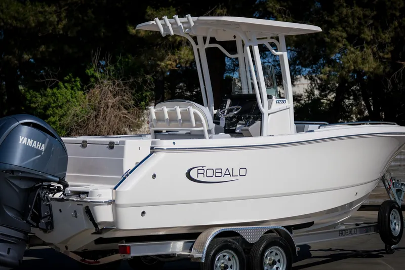 Slide: The Image of 2025 Robalo R230 Center Console boat on trailer with Yamaha engine. - 3