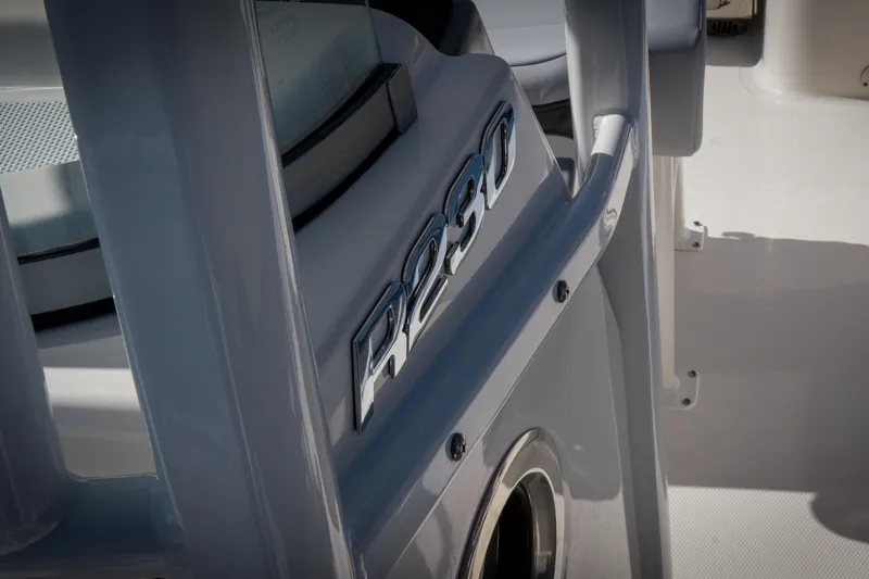 Slide: The Image of 2025 Robalo R230 Center Console boat detail with sleek design and logo. - 7