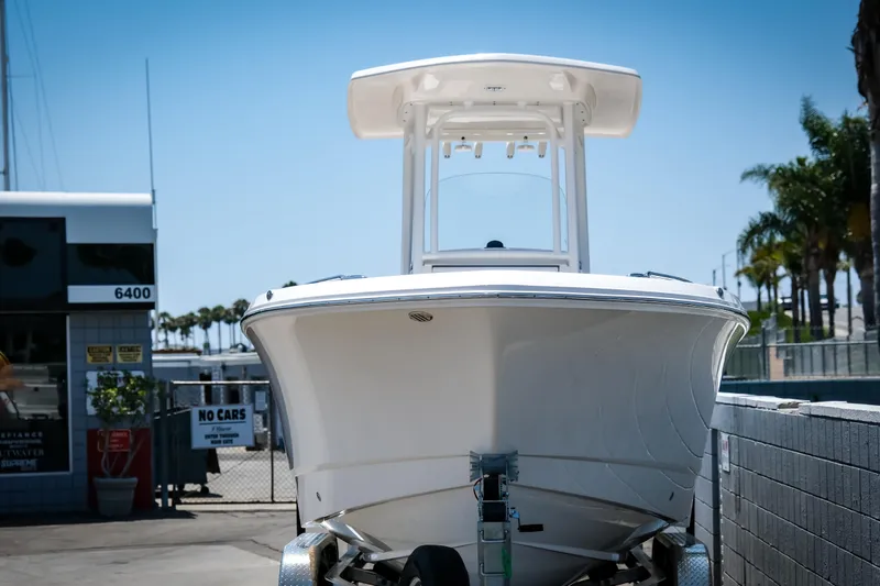 Slide: The Image of 2025 Robalo R230 Center Console boat on trailer, parked outdoors. - 4